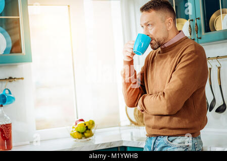 Nice thoughtful man having tea Stock Photo