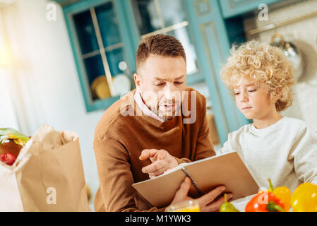 Nice pleasant man holding a notebook Stock Photo