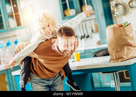 Happy nice man carrying his son Stock Photo