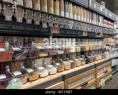 Bulk bins containing Rice, grains, flours, pasta, soup mixes, beans, cereals, dried fruits, nuts & seeds in Whole Foods Market store, Arlington, USA. Stock Photo