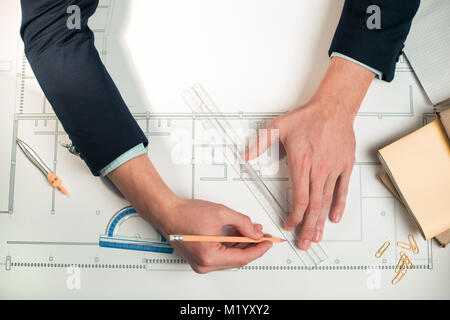 Young male hands sketching blueprint Stock Photo