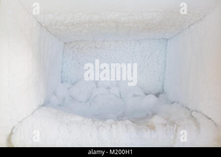 Empty of a refrigerator. Ice buildup inside of a freezer walls. Stock Photo