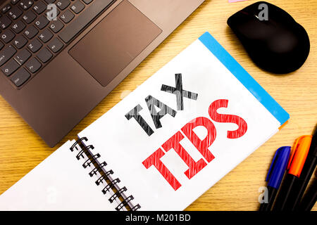 Handwritten text caption showing Tax Tips. Business concept writing for Taxpayer Assistance Refund Reimbursement written on notepad with space on old  Stock Photo