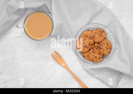 Still life of freshly baked chocolate chip cookies on plate on table. Stock Photo