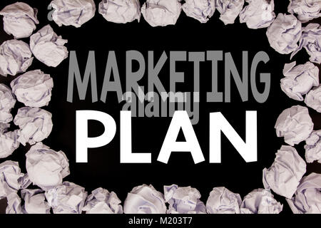 Word, writing Marketing Plan. Business concept for Planning Successful Strategy written on black background with copy space on background with folded  Stock Photo