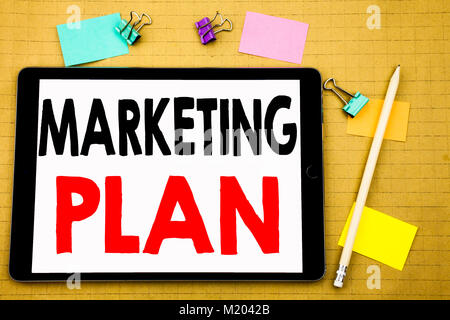 Hand writing text caption inspiration showing Marketing Plan. Business concept for Planning Successful Strategy Written on tablet, wooden background w Stock Photo