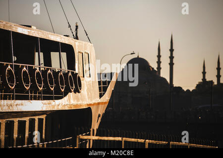 Istanbul, Turkey; September 10, 2017: Silhouette of Yeni Mosque and Istanbul Ferry Stock Photo