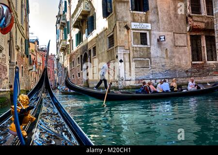 VENICE, ITALY - MAY 21, 2017: When taking a ride on a gondola in Venice, you can find another tourists on the canals taking a ride too. Stock Photo