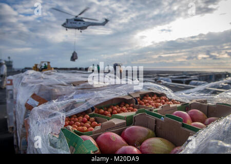 PACIFIC OCEAN (Nov. 9, 2017) Sailors transport cargo dropped off from an SA-330 Puma helicopter, assigned to the dry cargo and ammunition ship USNS Amelia Earhart (T-AKE 6), on the flight deck of the aircraft carrier USS Theodore Roosevelt (CVN 71). Theodore Roosevelt is currently underway for a regularly scheduled deployment to the U.S. 7th Fleet area of operations in support of maritime security operations and theater security cooperation efforts. (U.S. Navy Stock Photo