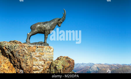 A mountain goat sculpture min bronze at the Piz Nair mountain range above St. Moritz, Switzerland, Europe. Stock Photo
