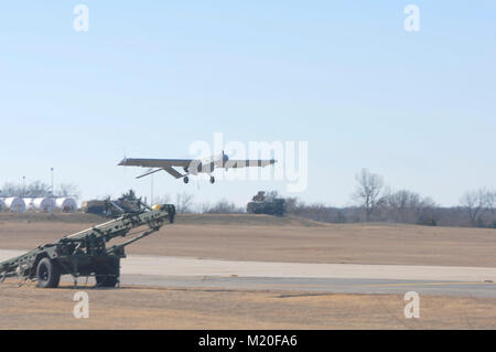 Members of Det. 1, Delta Company, 545th Brigade Engineer Battalion, 45th Infantry Brigade Combat Team, Oklahoma Army National Guard, brave the below-freezing temperatures to conduct their required Additional Flight Training Period (ATFP) hours with the RQ-7 Bravo or 'Shadow' at Muldrow Army Heliport in Lexington, Oklahoma, Jan. 29. This is the first time the operators of the Unmanned Aircraft System (UAS) conducted training at Lexington. (U.S. Army National Guard photo by Staff Sgt. Jason Lay) Stock Photo