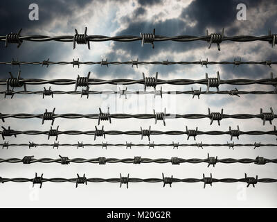 Barbed wired on dark cloudy sky background. 3D illustration. Stock Photo