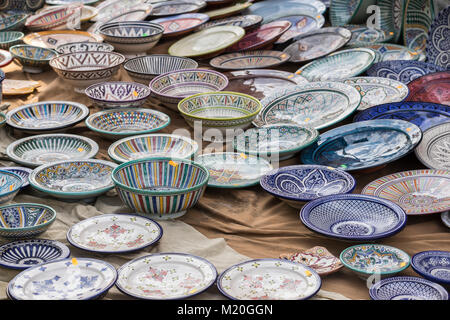 Porcelain, hand-painted dishes of a multitude of colors in a traditional art market Stock Photo