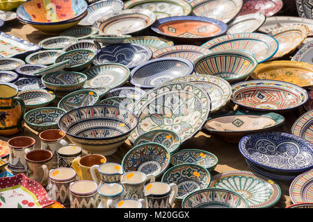 hand-painted dishes of a multitude of colors in a traditional art market Stock Photo