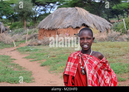 Maasai girl smiles near her hut, Ngorongoro Conservation Area, Tanzania Stock Photo