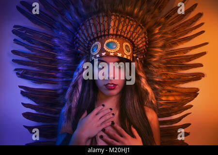 Headdress, beautiful girl with plume of american indian feathers Stock Photo