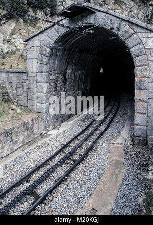 Old tunnel train of The Vall de Nuria Rack Railway. It is a mountain railway in the Pyrenees exit in Vall de Nuria Stock Photo