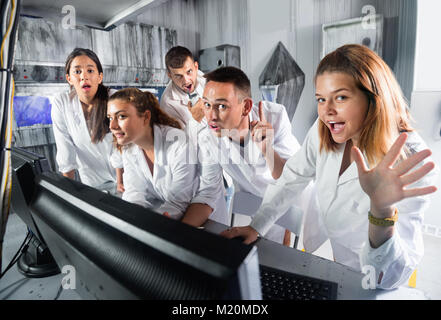 Happy  cheerful adults laughing and grimacing in quest room-laboratory Stock Photo