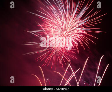 Bright pink firework show against background of dark sky Stock Photo