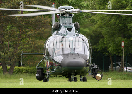 BONN, GERMANY - MAY 22, 2010: German Border patrol EC-155 helicopter of the Bundesgrenzschutz taking off from a grass field at Bonn-Hangelar airport. Stock Photo