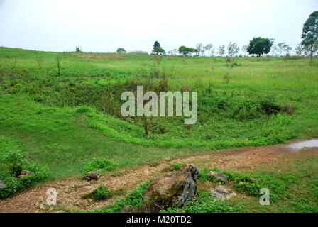 Bomb craters from the Vietnam War surround giant megalithic stone urns at the Plain of Jars archaeological site in Loas. This area is the world's most Stock Photo