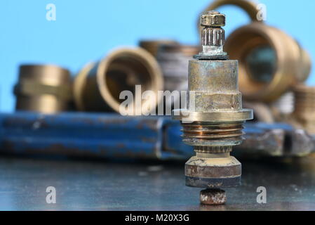 Plumbing Parts and Repair Old brass Tap Valve and Tools Stock Photo