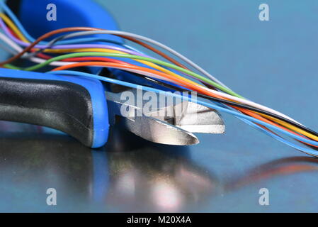 Electrical tools pliers and wire on metal surface Stock Photo