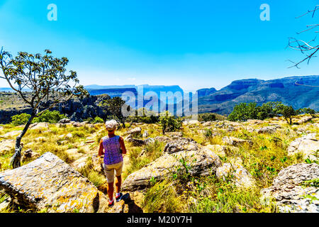 Senior woman enjoying the view of the highveld and the Blyde River Dam in the Blyde River Canyon Reserve, along the Panorama Route in Mpumalanga Provi Stock Photo