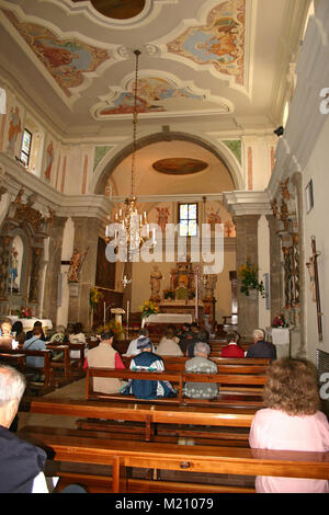 Interior view of Chiesa di San Matteo Apostolo/ St. Matthew Church in Ravascletto, Italy. Sunday service. Stock Photo