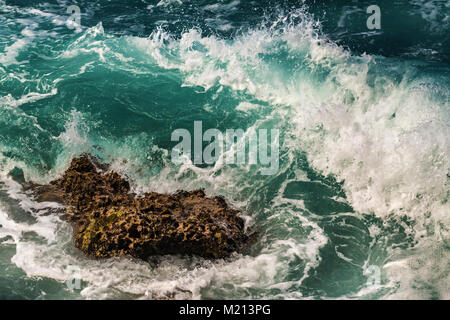 Wave crashing on lava rock in Oahu, Hawaii Stock Photo