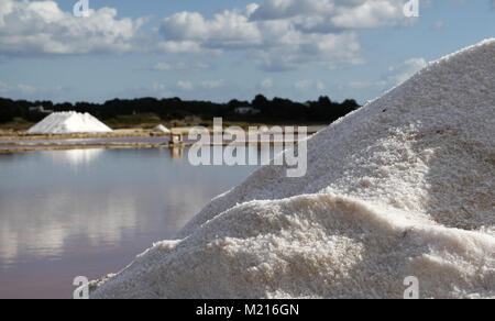 Campos, Balearic Islands, Spain. 3rd Feb, 2018. Solar salt works are man-made systems exploited for the extraction of salt, by solar and wind evaporation of seawater. Salt production achieved by traditional methods is associated with landscapes and environmental and patrimonial values generated throughout history.Around 15,000 tones of salt is harvested each year in the south east of Mallorca, in Salines of Colonia Saint Jordi. Man-made salt lakes are formed by pumping sea water from Es Trenc (purified in-route) where salt crusts in hot and windy conditions. Some of these crusts are us Stock Photo