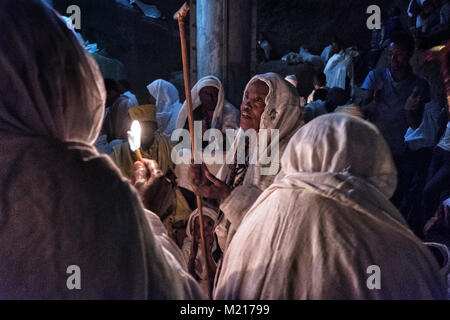 Lalibela, Amhara Region, Ethiopia. 6th Jan, 2018. Pilgrims singing at night outside the Biete Medhane Alem (House of the Saviour of the World).During the first days of January, thousands of Ethiopian Orthodox Christian pilgrims go to the city of Lalibela to visit the ''New Jerusalem''. This holy city is composed of 11 interconnected churches carved by hand that are connected through a series of labyrinths and tunnels.The first days of January mark the celebration of Genna (also known as Ledet), which is the Christmas version of the Ethiopian calendar. During this celebration, the pilgrim Stock Photo