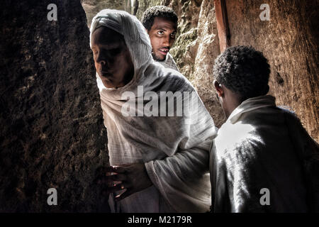 Lalibela, Amhara Region, Ethiopia. 7th Jan, 2018. A woman kissing the wall of the Biete Denagel (House of Virgins) before entering.During the first days of January, thousands of Ethiopian Orthodox Christian pilgrims go to the city of Lalibela to visit the ''New Jerusalem''. This holy city is composed of 11 interconnected churches carved by hand that are connected through a series of labyrinths and tunnels.The first days of January mark the celebration of Genna (also known as Ledet), which is the Christmas version of the Ethiopian calendar. During this celebration, the pilgrims travel to Stock Photo