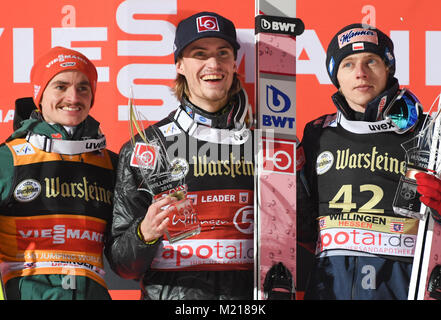 Willingen, Germany. 03rd Feb, 2018. (l-r) Richard Freitag of Germany (2nd), winner Daniel Andre Tande of Norway and David Kubacki of Poland (3rd) pictured during the victory ceremony at the FIS Ski Jumping World Cup in Willingen, Germany, 03 February 2018. Credit: Arne Dedert/dpa/Alamy Live News Stock Photo
