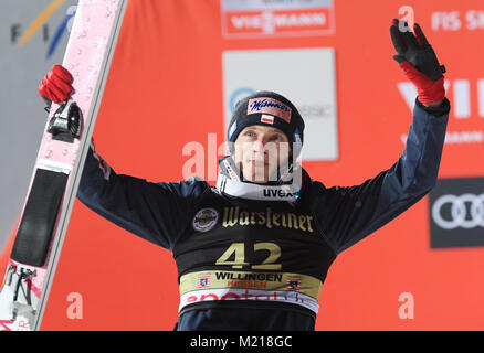 Willingen, Germany. 03rd Feb, 2018. David Kubacki of Poland (3rd) celebrates on his way to the victory ceremony at the FIS Ski Jumping World Cup in Willingen, Germany, 03 February 2018. Credit: Arne Dedert/dpa/Alamy Live News Stock Photo