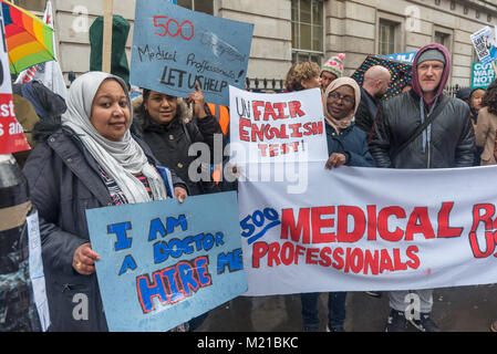London, UK. 3rd February 2018. Foreign medical professinals protest about the ynfair English test which stops them practising in the UK as tens of thousands march in support of the NHS through London to a rally at Downing St calling on the Government to stop blaming patients, nurses, doctors, immigrants, flu and the elderly for the crisis in the health service and to fund it properly and bring it back into public hands from the waste and demands of private profit. Outsourcing of services has damaged the efficiency of the NHS and created dangerously low standards of hygiene, while expensive PFI Stock Photo