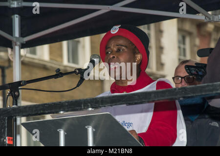 London, UK. 3rd February 2018. Royal College of Nursing President Cecilia Anim speaks at the Downing St rally after the end of the march by tens of thousands through London in support of the NHS calling for the Government to stop blaming patients, nurses, doctors, immigrants, flu and the elderly for the crisis in the health service and to fund it properly and bring it back into public hands from the waste and demands of private profit. Outsourcing of services has damaged the efficiency of the NHS and created dangerously low standards of hygiene, while expensive PFI building contracts have left Stock Photo