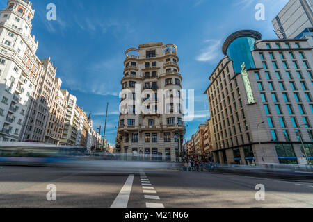 Madrid, Spain - January 23, 2018 : Motion blurred people and cars, Morning heavy traffic, historic buildings in Gran Via, Calle Princesa and Leganitos Stock Photo