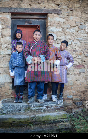 Prakhar Lhakhang, Bumthang, Bhutan.  Bhutanese family in Traditional Dress (Gho). Stock Photo