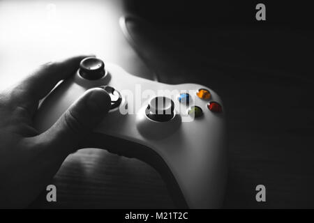 hands with a gamepad, gaming process, closeup view Stock Photo