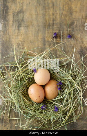 Chicken and quail eggs in a wooden box. Rustic style, selective focus. Stock Photo