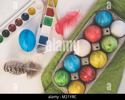 Painted easter eggs on a white, wooden table. Happy Easter Stock Photo