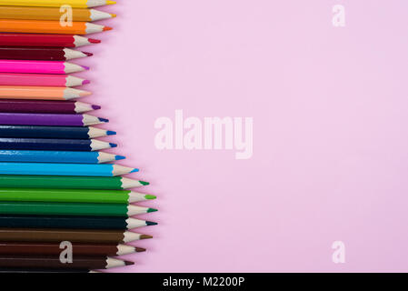 Colored pencils isolated on pink background. group of colored pencil arrangement Stock Photo