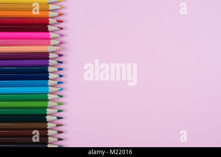 Colored pencils isolated on pink background. group of colored pencil arrangement Stock Photo