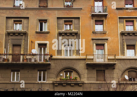 Several roman windows on a orange and brown wall Stock Photo
