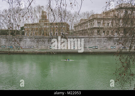 Two men riding a canoe in the winter of Rome Stock Photo