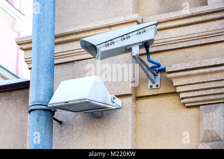 Surveillance camera mounted on the wall of the building Stock Photo