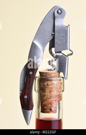 Opening bottle of wine with corkscrew Stock Photo