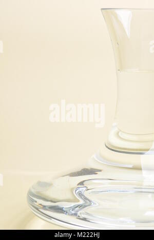 Glass carafe with water on beige background Stock Photo