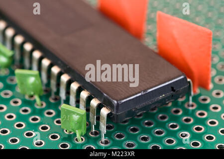 Big vintage chip and capacitors on Printed Circuit Board Stock Photo